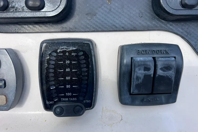 Slide: The Image of Control panel of a 2006 Grady-White Tournament 205 boat with trim tab indicators. - 35