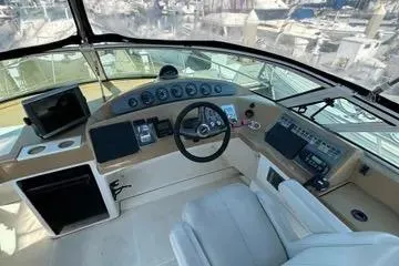 Slide: The Image of 2002 Carver 350 Mariner helm with steering wheel, gauges, and navigation equipment. - 10