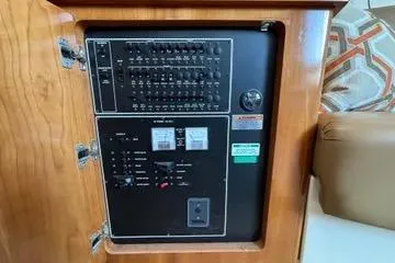 Slide: The Image of Electrical panel inside a 2002 Carver 350 Mariner boat, featuring switches and controls. - 11