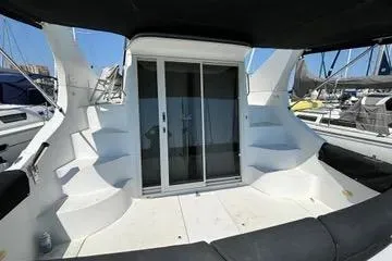 Slide: The Image of 2002 Carver 350 Mariner yacht deck with sliding glass doors and seating area. - 14