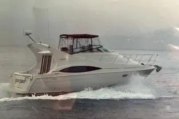 Slide: The Image of 2002 Carver 350 Mariner yacht cruising on open water. - 15