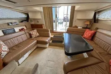 Slide: The Image of Interior of 2002 Carver 350 Mariner yacht with spacious seating and table. - 6