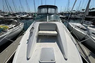 Slide: The Image of 2002 Carver 350 Mariner yacht docked in a marina, surrounded by sailboats. - 7
