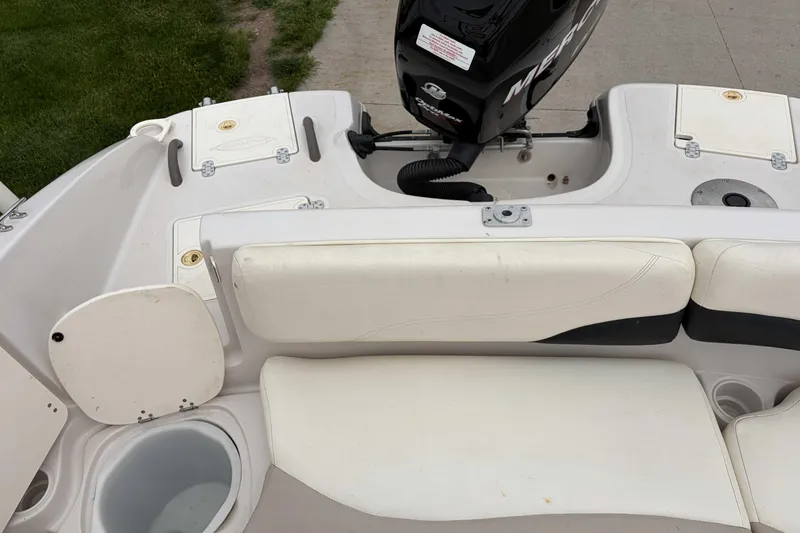 Slide: The Image of 2007 Tahoe 215 OB boat interior with seating and outboard motor. - 3