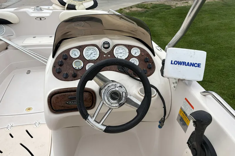 Slide: The Image of 2007 Tahoe 215 OB boat dashboard with steering wheel and Lowrance navigation system. - 4