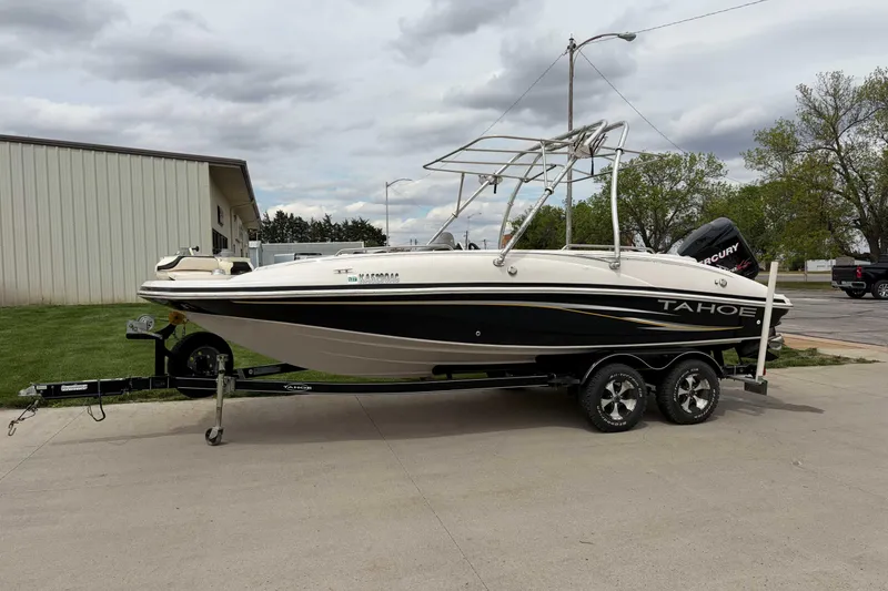 Slide: The Image of 2007 Tahoe 215 OB boat on trailer, parked outdoors, with overcast sky. - 6