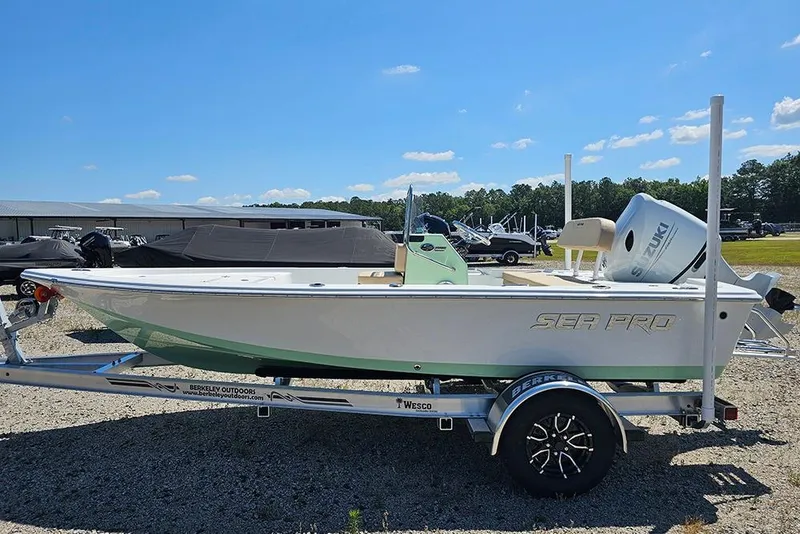 The Image of 2026 Sea Pro 172 Bay boat on trailer, outdoors under clear blue sky. - 0