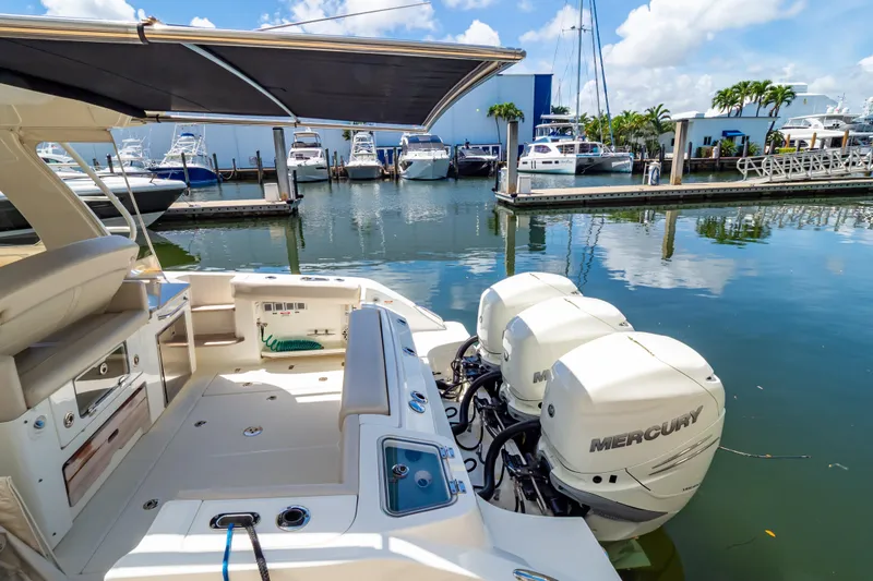 Slide: The Image of 2019 Boston Whaler 350 Realm with Mercury engines docked at marina. - 44