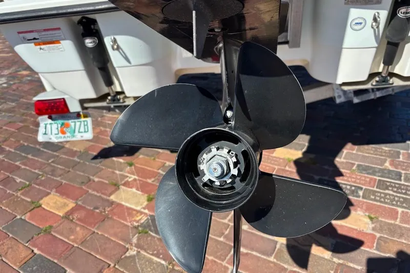 Slide: The Image of Close-up of a 2009 Ranger Banshee boat propeller on a brick driveway. - 11