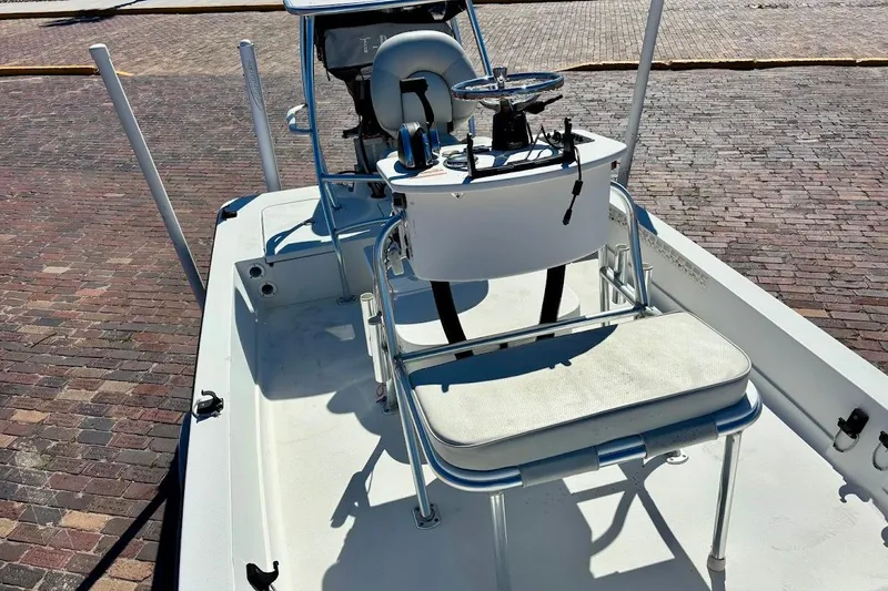 Slide: The Image of 2009 Ranger Banshee boat interior with steering console and seating on brick pavement. - 12