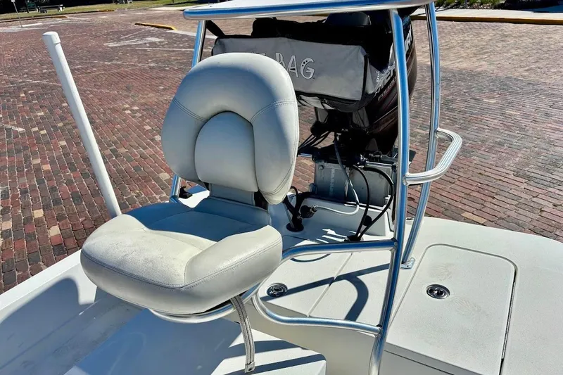 Slide: The Image of 2009 Ranger Banshee boat with cushioned seat and motor on brick pavement. - 14