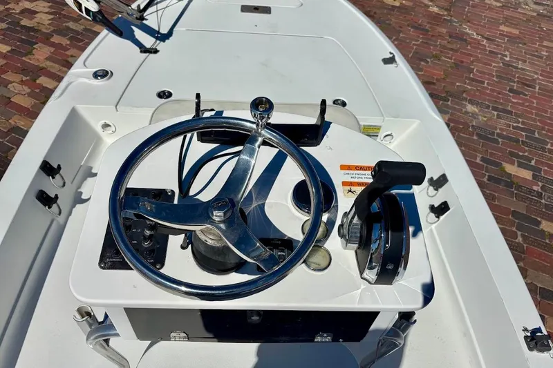 Slide: The Image of 2009 Ranger Banshee boat steering console with controls and warning label. - 16