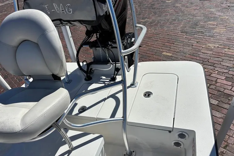 Slide: The Image of 2009 Ranger Banshee boat interior with white seating and metal railings. - 17