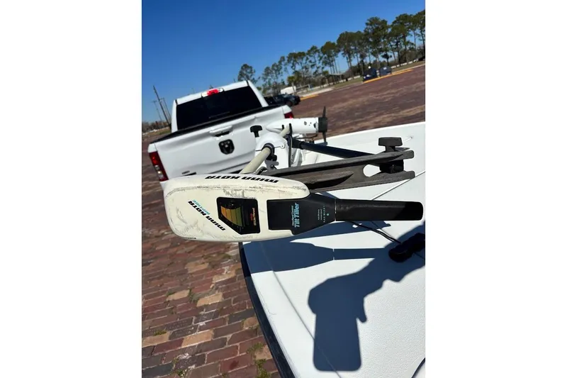 Slide: The Image of 2009 Ranger Banshee boat with Minn Kota trolling motor, parked on brick pavement. - 22