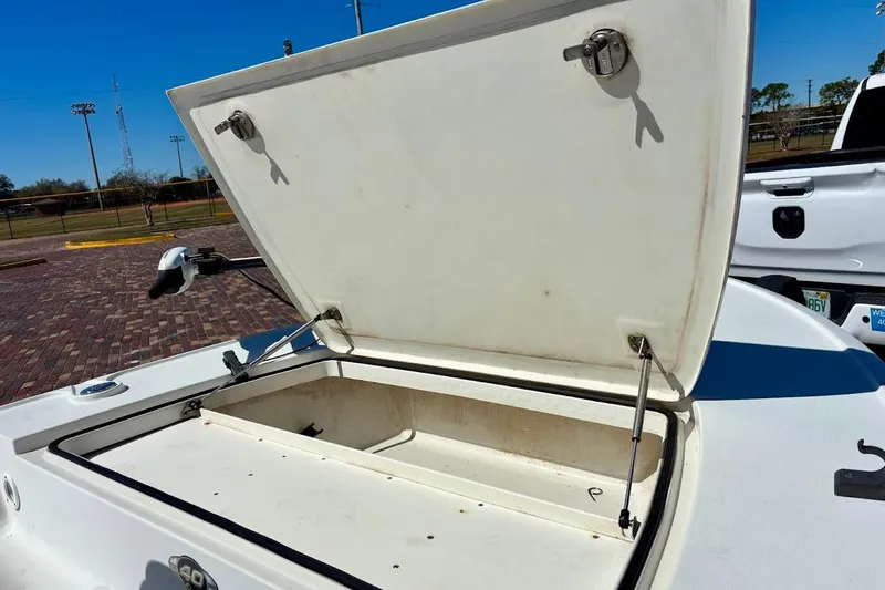 Slide: The Image of Open storage compartment on a 2009 Ranger Banshee boat, parked outdoors. - 24