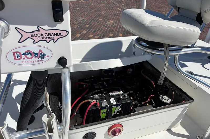 Slide: The Image of 2009 Ranger Banshee boat battery compartment with fishing gear stickers and seating. - 27