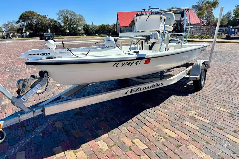 Slide: The Image of 2009 Ranger Banshee boat on EZ Loader trailer, parked on brick pavement. - 3