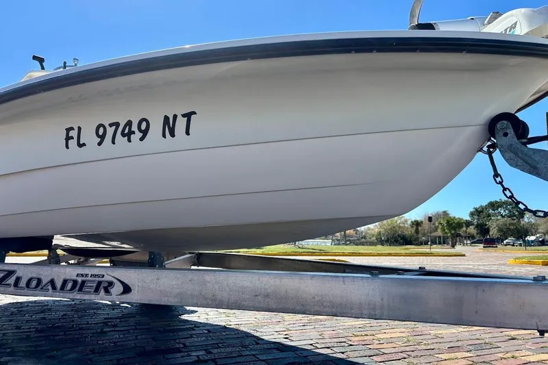 Slide: The Image of 2009 Ranger Banshee boat on trailer, registration FL 9749 NT, sunny day. - 6