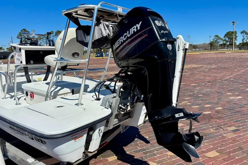 Slide: The Image of 2009 Ranger Banshee boat with Mercury 60 outboard motor on brick pavement. - 9
