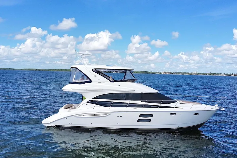 The Image of 2013 Meridian 441 Sedan yacht cruising on a sunny day with blue skies and calm waters. - 0