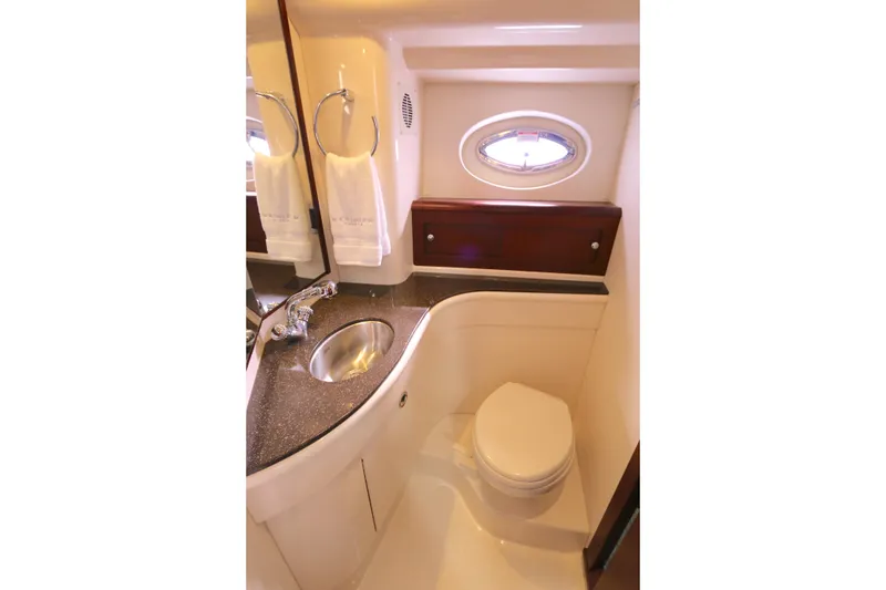 Slide: The Image of Luxurious bathroom in 2013 Meridian 441 Sedan yacht with sink, toilet, and porthole window. - 10