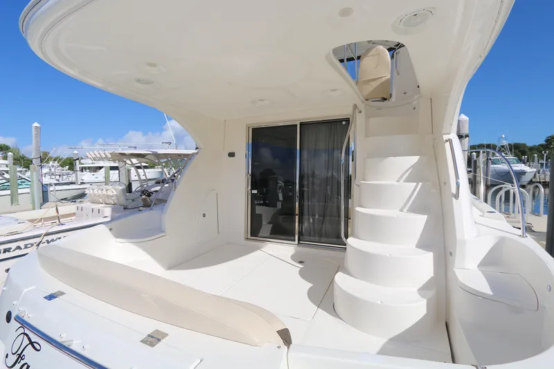 Slide: The Image of 2013 Meridian 441 Sedan yacht with sleek white deck and spiral staircase. - 11