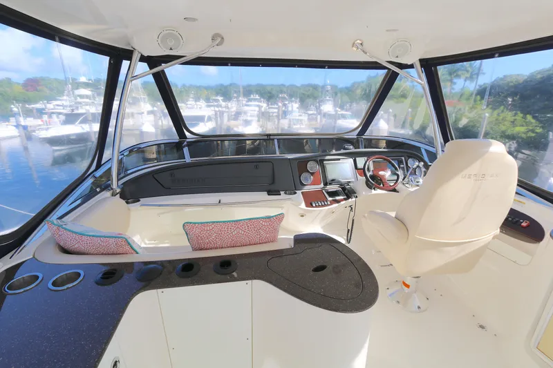 Slide: The Image of Interior view of 2013 Meridian 441 Sedan yacht cockpit with helm and seating. - 12