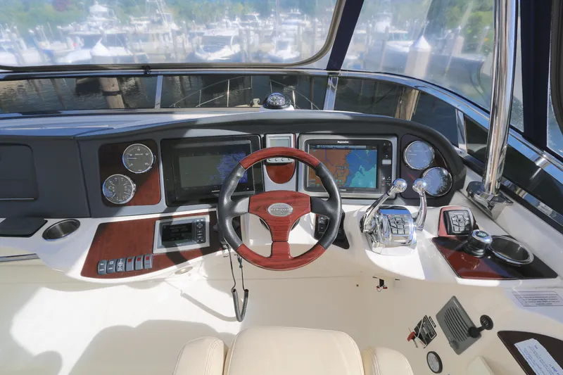 Slide: The Image of Cockpit of 2013 Meridian 441 Sedan with navigation screens and controls. - 13