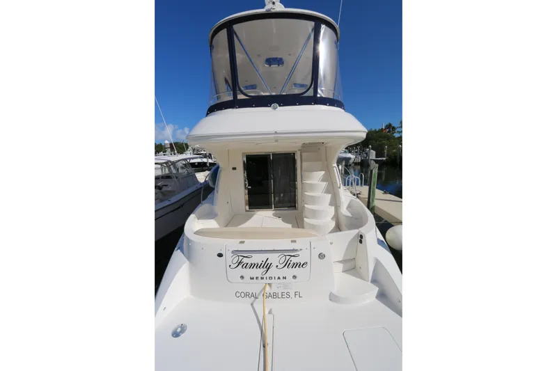 Slide: The Image of 2013 Meridian 441 Sedan yacht docked, featuring spiral staircase and "Family Time" nameplate. - 17