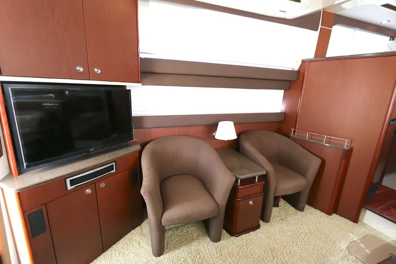 Slide: The Image of Interior of 2013 Meridian 441 Sedan yacht with TV, chairs, and wooden cabinetry. - 2
