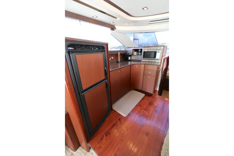 Slide: The Image of Luxurious kitchen interior of 2013 Meridian 441 Sedan yacht with wood flooring and modern appliances. - 4