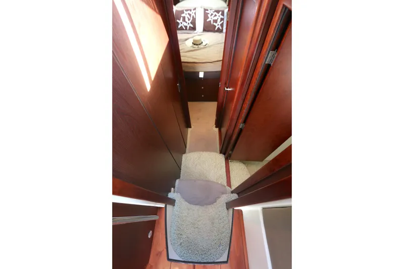 Slide: The Image of 2013 Meridian 441 Sedan interior hallway with carpeted steps and wooden paneling. - 5