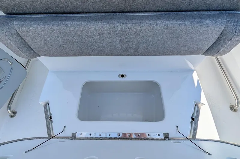 Slide: The Image of 2025 Sea Hunt Ultra 255 SE boat interior with cushioned seating and steering wheel. - 10