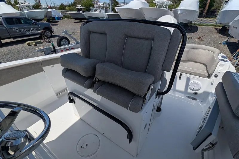 Slide: The Image of 2025 Sea Hunt Ultra 255 SE boat seating, featuring plush gray upholstery and ergonomic design. - 11