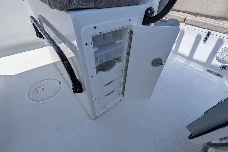 Slide: The Image of 2025 Sea Hunt Ultra 255 SE boat dashboard with Garmin navigation system and steering wheel. - 13