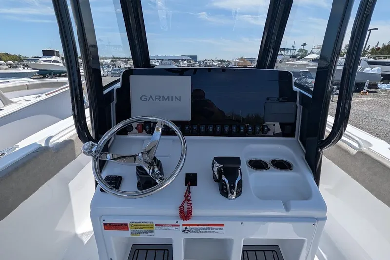 Slide: The Image of 2025 Sea Hunt Ultra 255 SE boat with T-top and Garmin electronics at marina. - 14