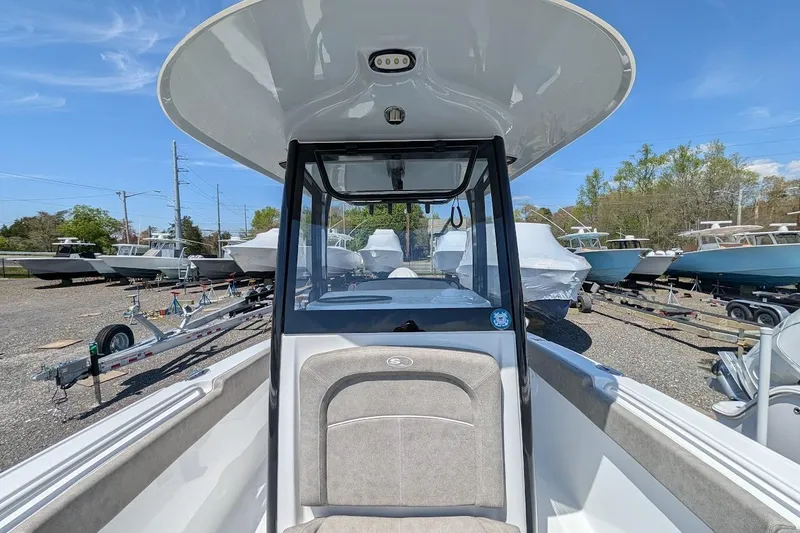 Slide: The Image of Bow seating area of 2025 Sea Hunt Ultra 255 SE with cup holders and cushioned seats. - 20