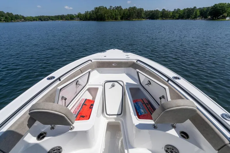 Slide: The Image of Manufacturer Provided Image: 2025 Sea Hunt Ultra 255 SE boat interior with cushioned seating on a calm lake. - 26