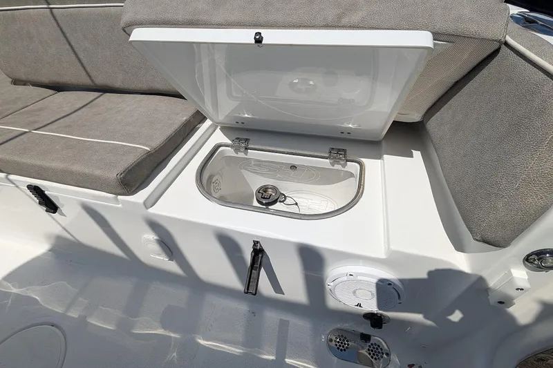 Slide: The Image of 2025 Sea Hunt Ultra 255 SE boat interior with cushioned seating and storage. - 7