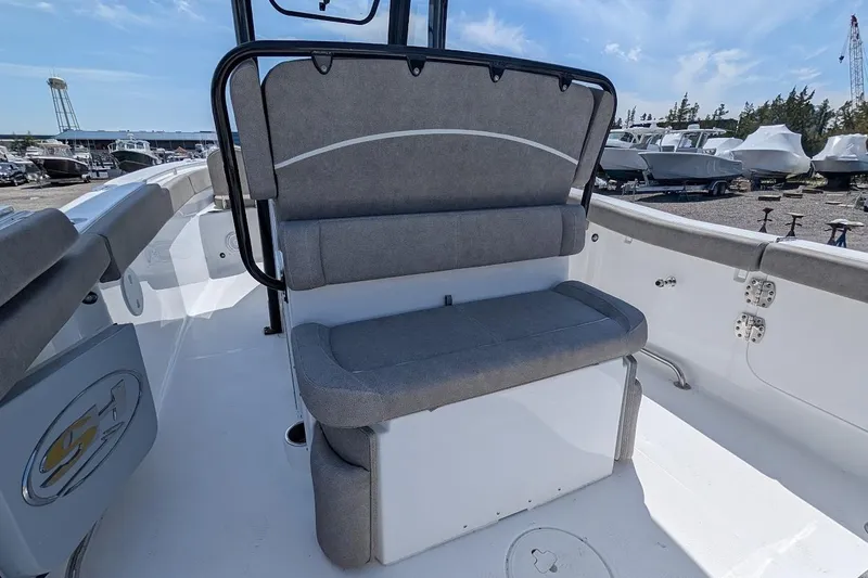 Slide: The Image of 2025 Sea Hunt Ultra 255 SE boat seating with gray cushions and storage compartment. - 8