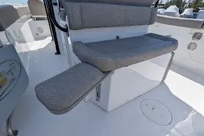 Slide: The Image of 2025 Sea Hunt Ultra 255 SE boat interior with storage compartment and cushioned seating. - 9