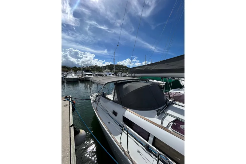 Slide: The Image of 2011 Jeanneau Sun Odyssey 44i sailboat cockpit with dual steering wheels, docked in marina. - 18