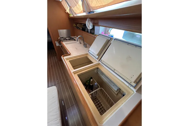 Slide: The Image of Engine compartment of a 2011 Jeanneau Sun Odyssey 44i sailboat, showcasing mechanical components. - 27