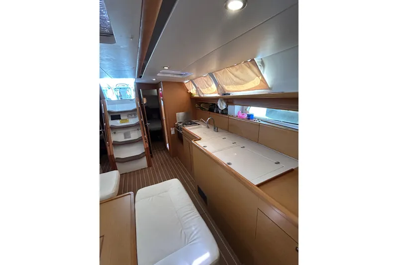 Slide: The Image of Galley kitchen in 2011 Jeanneau Sun Odyssey 44i yacht with open storage compartments. - 28