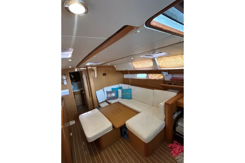 Slide: The Image of Interior of 2011 Jeanneau Sun Odyssey 44i yacht, featuring a modern kitchen and seating area. - 29