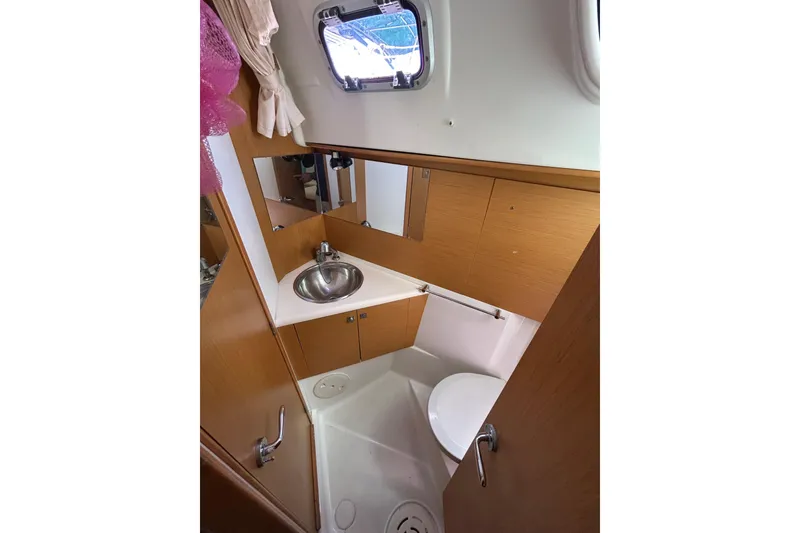 Slide: The Image of Cozy cabin interior of 2011 Jeanneau Sun Odyssey 44i sailboat with luggage. - 32
