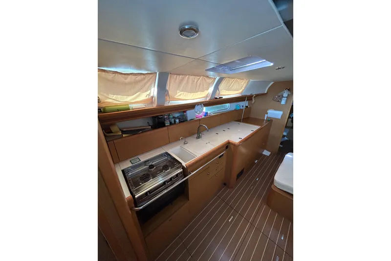Slide: The Image of Cozy cabin interior of 2011 Jeanneau Sun Odyssey 44i sailboat with wooden finish. - 34