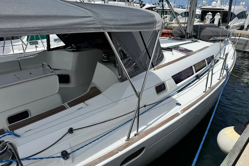 Slide: The Image of 2011 Jeanneau Sun Odyssey 44i sailboat docked at marina, featuring sleek design and spacious cockpit. - 42
