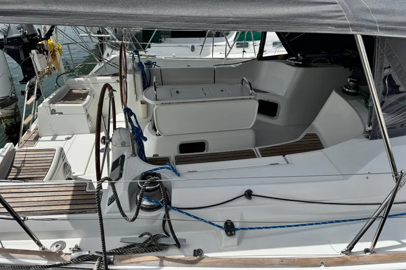 Slide: The Image of Cockpit of 2011 Jeanneau Sun Odyssey 44i sailboat with wooden accents and steering wheel. - 43