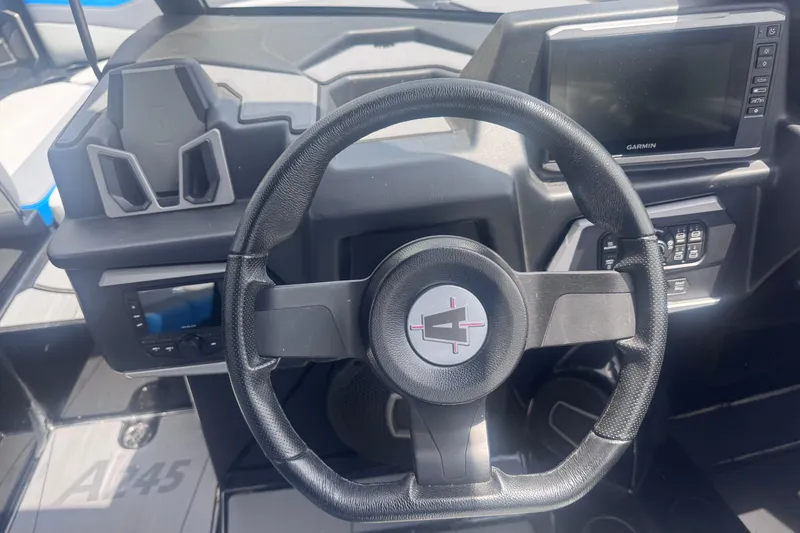 Slide: The Image of Steering wheel and dashboard of 2025 Axis A245 boat with Garmin display. - 7